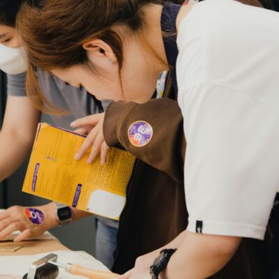 Participants engaging in a DIY craft workshop in Cần Thơ, Việt Nam, using various tools and materials.